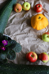 Autumn background with zucchini, apples, patisson. Place for text. 