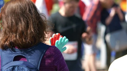 Woman cheering runners in 4k slow motion 60fps