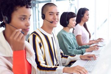 Customer service executives working on computer at desk