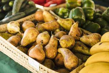 Worn pear in wicker basket for sale at fruit market