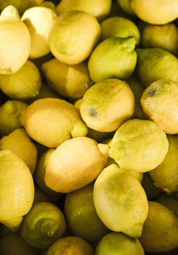 Display of fresh organic yellow lemons in fruit market