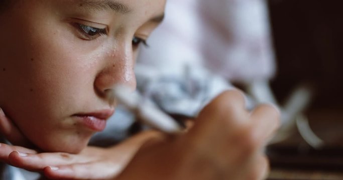 Close up side view of young teen woman draw on tablet