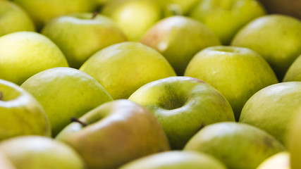 Arrangement of fresh organic green apple at farmers market