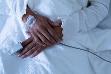 Female patient lying on the bed of hospital