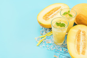 sweet and cold juice from melon in glasses against the background of melon sliced