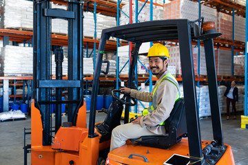 Male worker sitting in forklift and looking at camera in warehouse © WavebreakMediaMicro