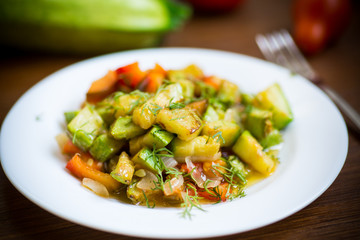 fried zucchini with red pepper, onions, tomatoes and other vegetables