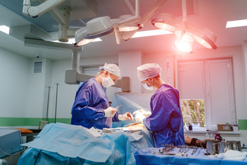 Medical team performing operation. Group of surgeon at work in operating theatre