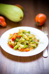 fried zucchini with red pepper, onions, tomatoes and other vegetables