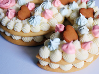 Homemade cake. Decorated with shortbread cookies and meringues. Number nine