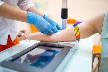 Nurse taking a blood sample, close up