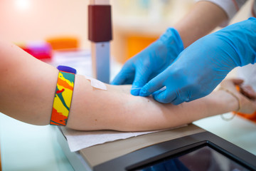 Nurse taking a blood sample, close up