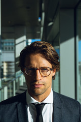 Fototapeta premium Businessman looking at camera in a modern office building