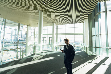 Businessman using mobile phone in a modern office building