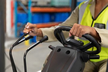 Female staff driving forklift in warehouse © wavebreak3
