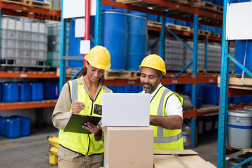 Male and female worker working together in warehouse