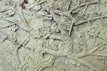 Vintage Thai Sculpture on Stone Wall.