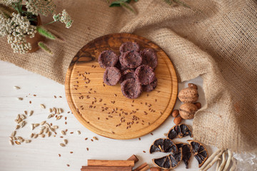 Sweets on a wooden tray around which are natural ingredients. Sugar-free dessert, healthy eating. Candies for diabetics.