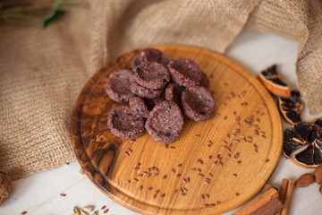 Sweets on a wooden tray around which are natural ingredients. Sugar-free dessert, healthy eating. Candies for diabetics.