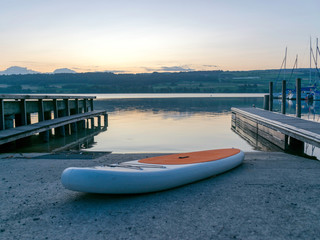 stand up board, boat dock, early view of the lake at dawn