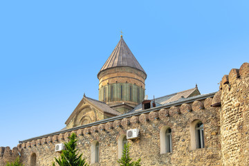 Fototapeta na wymiar Walls and cone-shaped dome of Svetitskhoveli temple