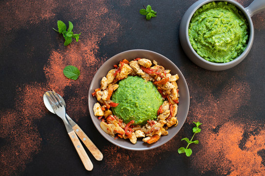 Mashed potatoes with green peas and corn served with chicken and vegetable stew. African cuisine, Kenyan cuisine, a traditional dish called mukimo. Top view, copyspace