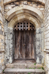 Fototapeta na wymiar Locked wooden door in old fortification wall
