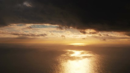 Aerial shot above ocean at sunset in 4K slow motion 60fps
