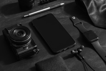 Mockup blank screen mobile phone with gentleman businessman's gadget and accessories. Travel equipment.