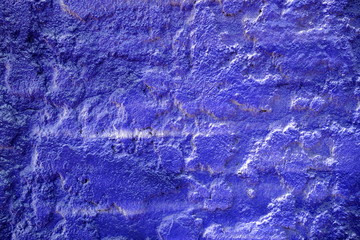 Blue Spray Painting on Stucco Wall Texture Background.