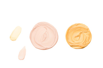Liquid body and face highlighter isolated on white background. Golden and beige color.  Body cream.