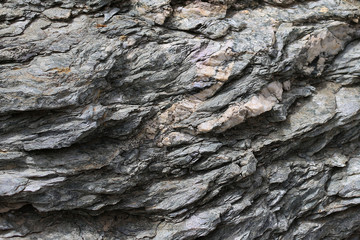 Background texture of rough cliff rock wall