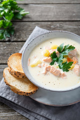 Finnish creamy soup with wild salmon, potatoes, carrots and parsley. Healthy food. Dieting. Finnish cuisine. Close up