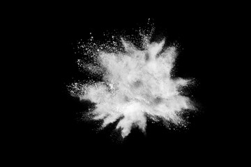 Freeze motion of white color powder exploding on dark background. 