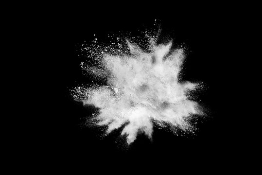 Freeze motion of white color powder exploding on dark background. 