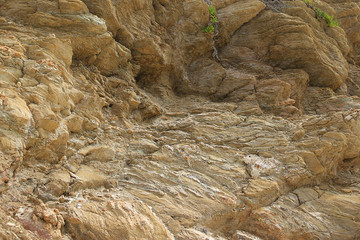 Background texture of rough cliff rock wall