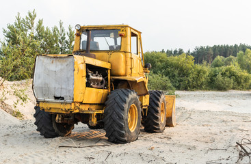 Bulldozer in the sand pit. Construction machinery after work.
