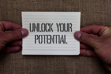 Fototapeta Text sign showing Unlock Your Potential question. Conceptual photo Maximize your Ability Use God given gift Man holding piece notebook paper jute background Communicating ideas obraz