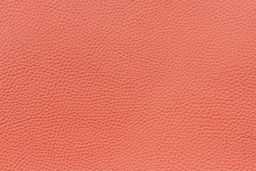 Salmon color textured leather background