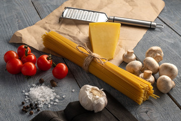 Raw ingredients on wooden table to make italian pasta