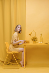 Portrait of  reading woman in a yellow scene