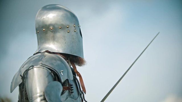 A man knight in the armor looking to the sky