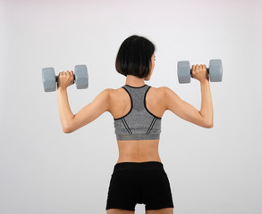sporty woman in sportswear with dumbbell doing fitness workout on white background. healthy sport lifestyle
