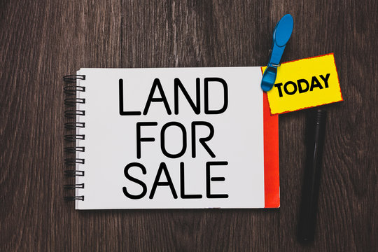 Writing note showing Land For Sale. Business photo showcasing Real Estate Lot Selling Developers Realtors Investment Open notebook white page clothespin holding reminder wooden background