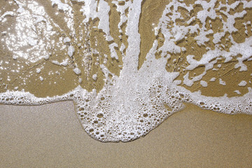 Wave on sandy beach background