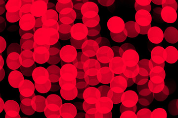 Unfocused abstract red bokeh on black background. defocused and blurred many round light
