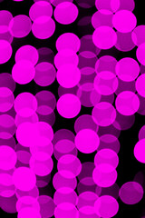 Unfocused abstract violet bokeh on black background. defocused and blurred many round light
