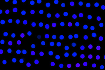 Unfocused abstract dark blue bokeh on black background. defocused and blurred many round light