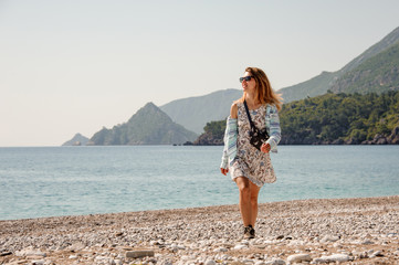 Young girl in light dress on a beach