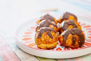 Profiterole with vanilla and chocolate sauce